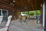 The two living areas are separated by the covered deck with grill and dining area.
